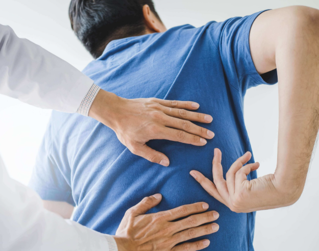 San Antonio physical therapist examining patient with lower back pain and sciatic nerve dysfunction San Antonio physical therapist examining patient with lower back pain and sciatic nerve dysfunction